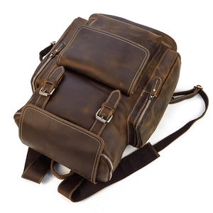 Detailed top view of dark brown crazy horse leather backpack with vintage metal buckles