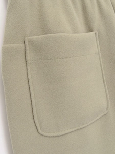 Detail of sage green wool drawstring hoodie pocket with premium stitching texture