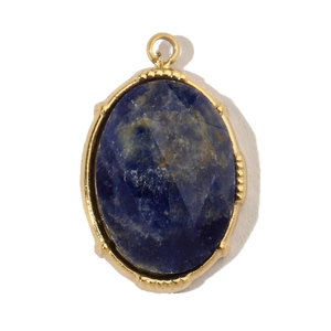 Detailed macro view of an oval blue natural stone pendant with a gold plated steel frame