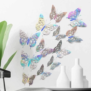 Hollow metallic silver butterflies with holographic finish displayed on a white wall