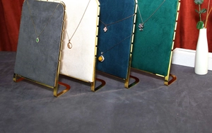 Detailed view of jewelry display stands in four velvet colors with golden metal L-frames