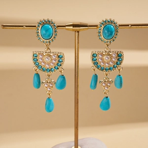 Vintage bohemian drop earrings with turquoise stones and faux pearls on a gold stand