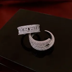 Adjustable silver ring with sparkling zircon stones and a classic CD logo centerpiece