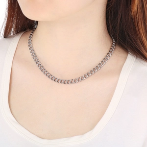 Women's stainless steel double-loop curb chain necklace worn on a model's neck