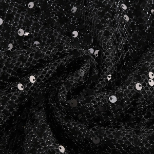 Macro detail of high-density black sequins on mesh fabric for elegant evening gowns