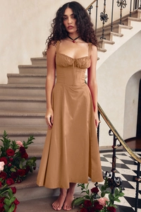 Elegant khaki strap midi dress shown on a model against a romantic spiral staircase