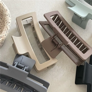 Matte Morandi rectangle hair claws in beige, brown, and green on a stone surface