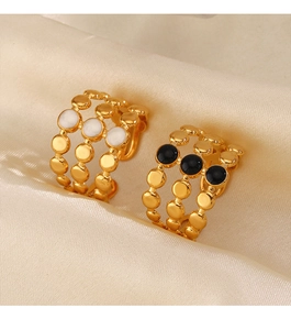 Detail of 18K gold plated triple row rings with black and white enamel dots on satin