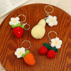 Handmade crochet fruit keychains featuring strawberry, pear, carrot, and cherry designs