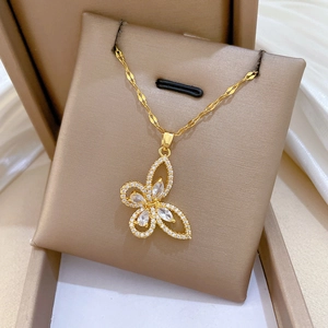 Detailed view of a gold-plated titanium steel butterfly pendant with zircon stones