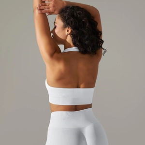 Detailed back view of white seamless knitted halter sports bra with ribbed texture