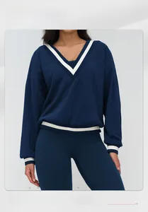 Detail of V-neck navy sports sweatshirt with white stripe accents on cuffs and collar