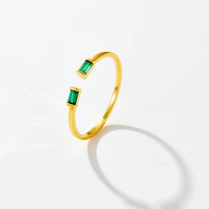 Macro detail of S925 silver adjustable ring with rectangular emerald green gemstones