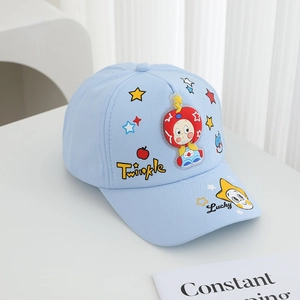 Detail of light blue kids baseball cap with star embroidery and cartoon character appliqué