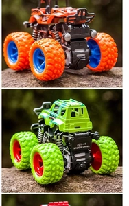 Outdoor close-up of colorful inertia 4WD monster truck toys on rocky surface
