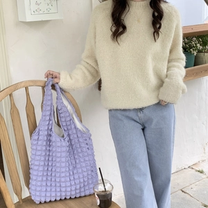 Detailed view of purple bubble textured puff shoulder bag with soft knit finish