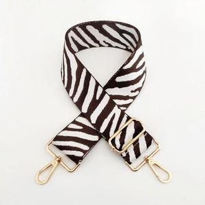 Close-up of zebra pattern wide replacement bag strap with golden metal swivel hooks