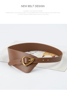 Detail of a brown leather waist belt featuring a distinctive golden triangle metal buckle