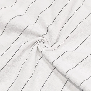 Close-up of white and black striped cotton linen fabric with soft natural folds