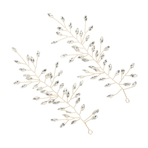 Detail of two gold wire-wrapped hair accessories with crystal leaves on white background