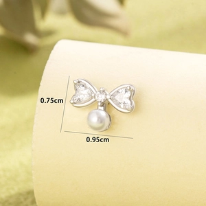 Silver bow stud earring with pearl and cubic zirconia detail measuring 0.95cm by 0.75cm
