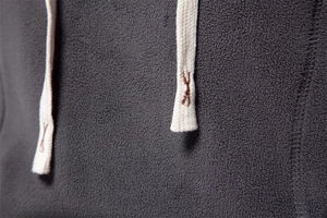 Macro detail of dark grey fleece hoodie fabric texture with white braided drawstring