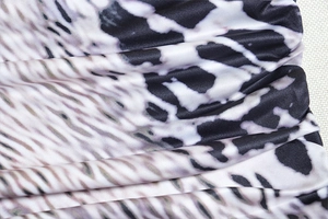 Macro view of black and white snake skin pattern on elastic polyester fabric texture