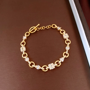 Detail of gold-plated chain bracelet with zircon rectangular charms and OT toggle clasp