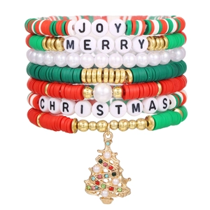 Detailed close-up of stacked red and green Christmas beaded bracelets with letter beads