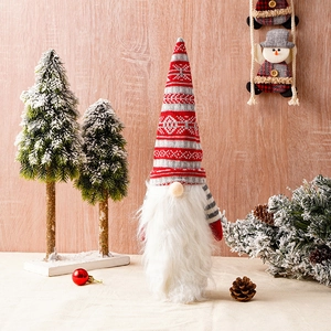 Detail of Christmas gnome wine bottle topper with red knitted hat and faux fur beard