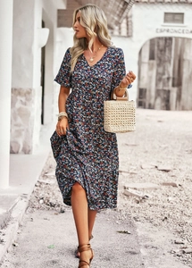 Detail of V-neck floral print dress in navy blue with a stylish A-line silhouette