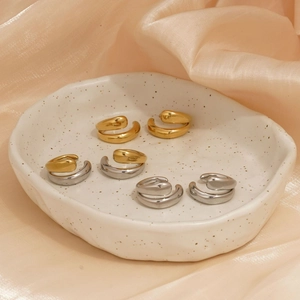 Minimalist double layer stainless steel ear cuffs in gold and silver on silk background