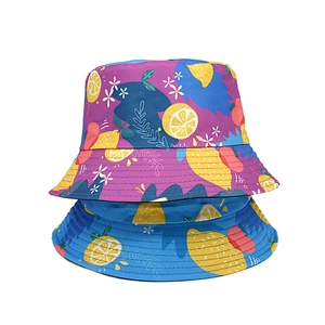 Detail of blue and purple reversible bucket hats with vibrant lemon and floral print