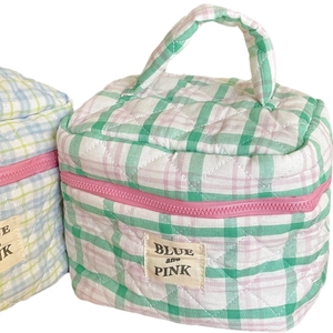Green and pink checkered quilted cotton makeup bag with a soft handle and zipper