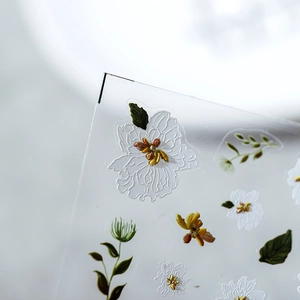 Floral nail art stickers with white flowers and embossed 3D texture on transparent film