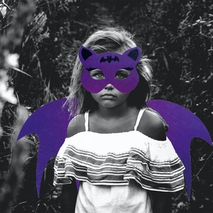 Close-up of purple felt cat mask and bat wings for children's Halloween cosplay