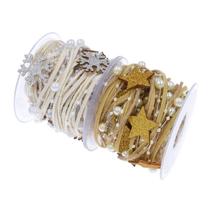Christmas tree ribbons with beads, glitter stars and snowflakes on wooden spools