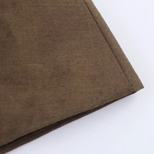 Detail of brown cotton-linen shirt dress showing high-quality stitching and fabric texture