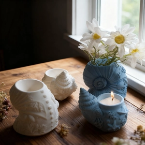 Conch shaped seashell candle holder mold in light blue and white with starfish relief
