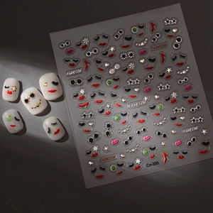 Detailed view of fashion nail art stickers with red lips, heels and golden star patterns