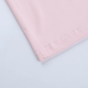 Detail of pink fabric showing professional double-needle stitching and smooth hemline finish