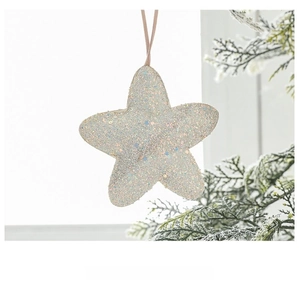 Close-up of sparkling white star ornament with pink ribbon on a festive pine branch
