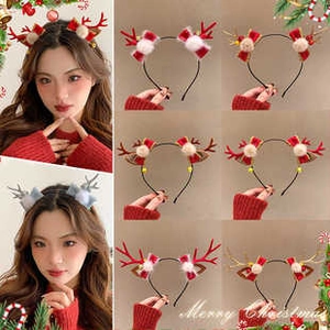 Close-up of glowing reindeer antler headbands with plush balls and festive bows