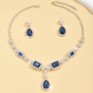 Elegant silver jewelry set with deep blue square stones and sparkling rhinestones