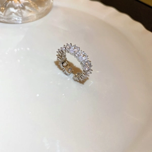 Macro side view of silver layered open ring with sparkling pavé zircons and pearls