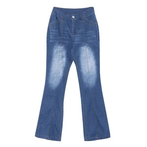 Detail of vintage washed blue denim flared jeans showing fabric texture and stitching