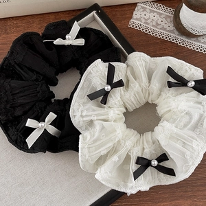 Lace scrunchies with contrasting bows and pearls in elegant black and white colors