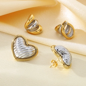 Chic two-tone 18K gold plated heart earrings and twisted hoops on champagne silk