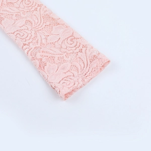 Detail shot of pink rose lace embroidery on sleeves with intricate floral texture