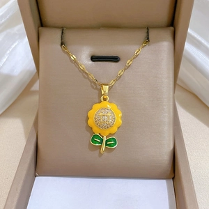 Detail of sunflower necklace with yellow enamel and sparkling crystals in a gift box
